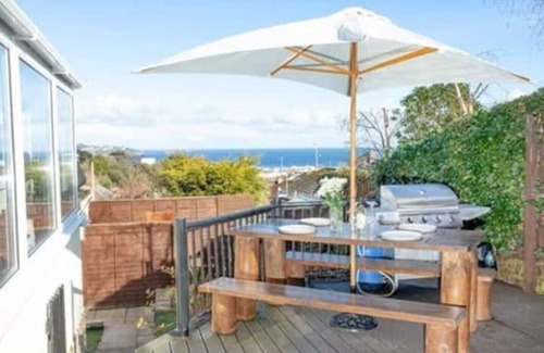 Paignton House | Large detached 3 bed bungalow. Great sea views. Hot tub with private gardens.