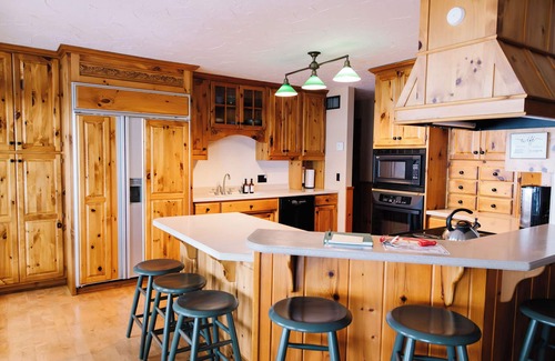 Nevis House | Luxury Lake Belle Taine retreat with private beach, sauna & four-season fun.