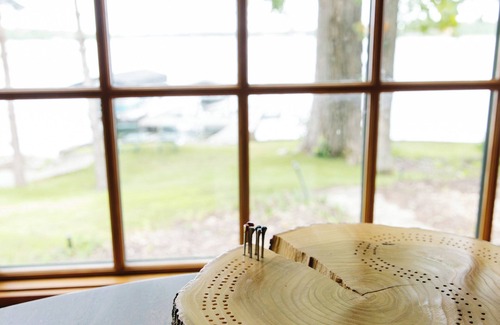 Nevis House | Luxury Lake Belle Taine retreat with private beach, sauna & four-season fun.
