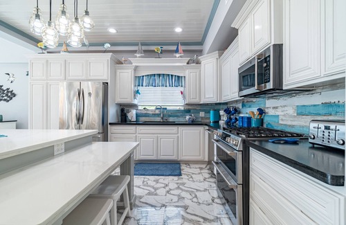 San Pedro House | Luxury Oasis: Serene Beachfront with Pool & Dock