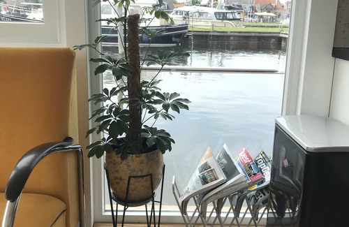 Stavoren Boat Rental | Modern houseboat in quiet harbor close to the IJsselmeer with SUPs and canoe