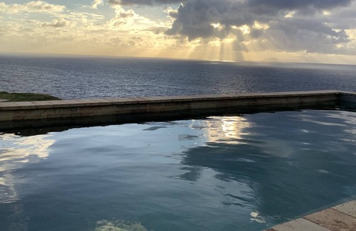 Windward Side Villa | Modern Luxury Villa in Flatlands. Pool. Walk to Beach. Sleeps 6. Ocean Views.