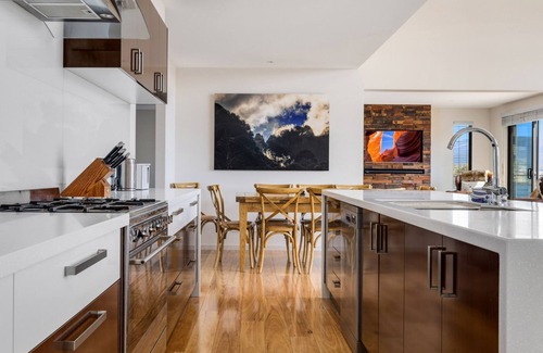East Jindabyne House | Moongate with beautifully styled, open plan living with panoramic views over Lake Jindabyne
