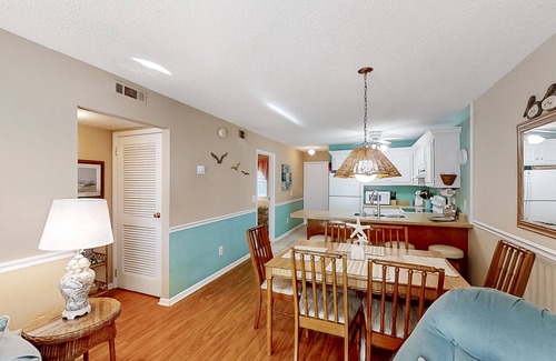 Crescent Beach Condo | Ocean-view condo near beach and golf with pool, balcony, central AC, & W/D