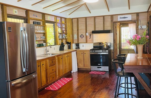 Caye Caulker Villa | OCEANFRONT ECO-CHIC HOME WITH INFINITY POOL, DOCK, AIR CONDITIONER & TV