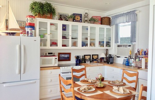 Bristol Cottage | Old fashioned designer front porch living by the sea with expansive water views.