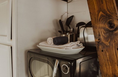 Meeker House | Our tiniest Tiny Home packs a punch! It contains a Queen bed in a loft accessed by a ladder. Sleeps: 2