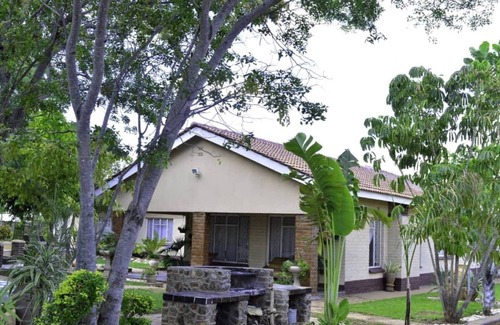 Kwekwe House | Palm and rose garden, golden acres