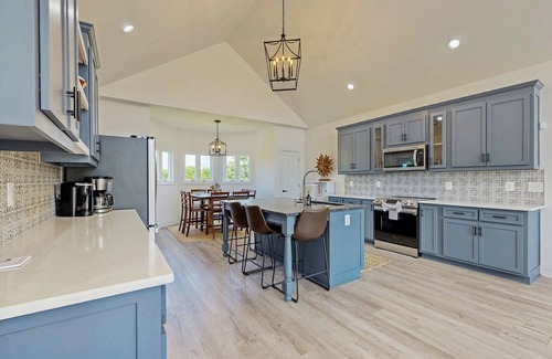 Orange House | Peaceful retreat with hot tub, fire pit, games, kayaks, and water view