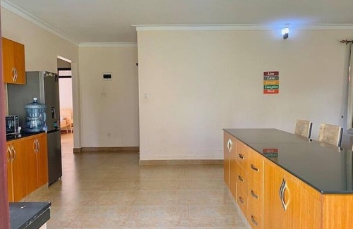 Kampala House | Quiet and peaceful hidden gem surrounded by lush greenery and vibrant flowers.n