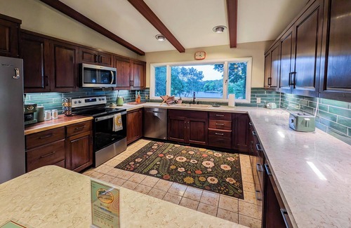 Fremont House | Retro lakeview stay with hot tub, game room, and nearby golf and skiing.