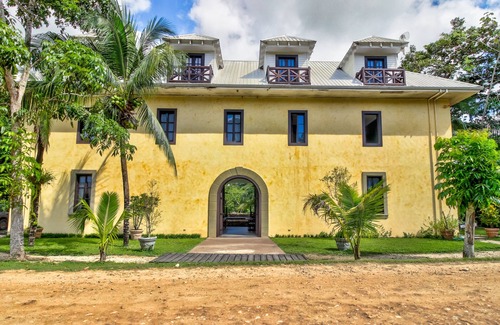Bullet Tree Falls House | Riverfront Retreat with Balcony, WiFi, Partial AC, Shared Pool