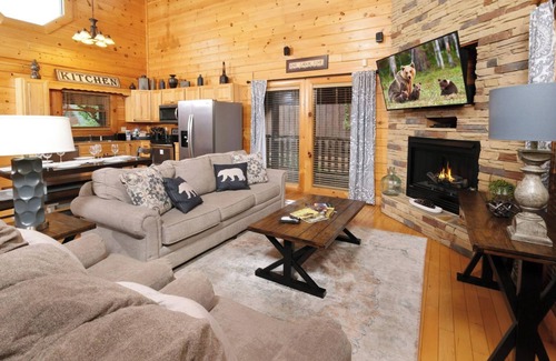 Sevierville Cabin | Rockin' in the Smokies | Enjoy grilling out, cozying up in the hot tub, or playing arcade games!
