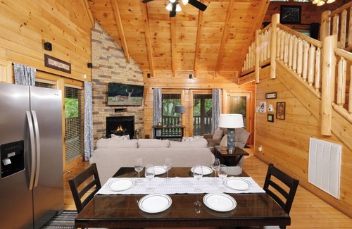 Sevierville Cabin | Rockin' in the Smokies | Enjoy grilling out, cozying up in the hot tub, or playing arcade games!