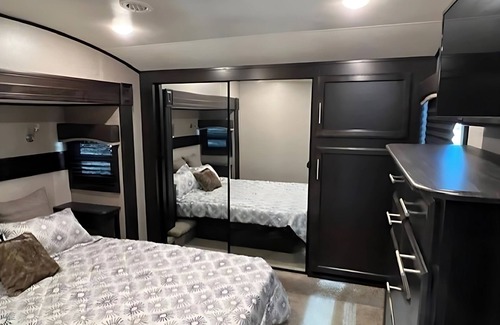 Kenora Resort | RV 5 Rustic Charm w/Queen Bed with Forest Background