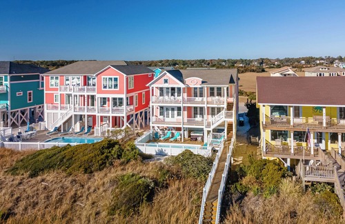 Holden Beach House | "Salty Pink Flamingo" is a stunning 6-bedroom, 4-bathroom oceanfront retreat with a private pool, hot tub, and elevator.