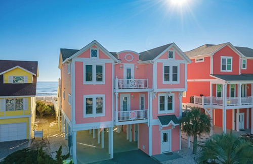Holden Beach House | "Salty Pink Flamingo" is a stunning 6-bedroom, 4-bathroom oceanfront retreat with a private pool, hot tub, and elevator.