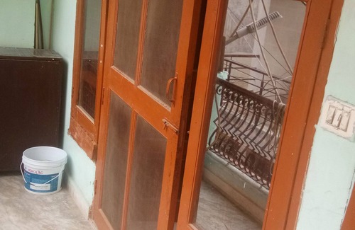 Mehrauli House | semi furnished Flat For Rent with one queen size bed and 4 chairs dining table