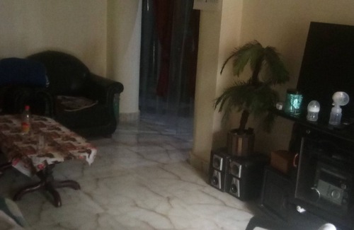 Mehrauli House | semi furnished Flat For Rent with one queen size bed and 4 chairs dining table