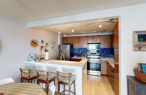Maple City Condo | Single-level lakefront hideaway with a deck, fireplace, & washer/dryer