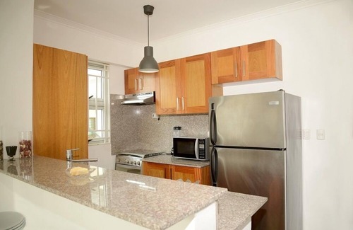 Ensanche Naco Apartment | Sleek,Bright Condo with City-View Terrace –Work & Play in Naco, Santo Domingo!