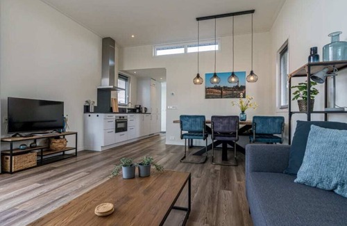 Burgh-Haamstede House | Spacious living room with a stylish interior, charming accents and a beautiful view of the expansive