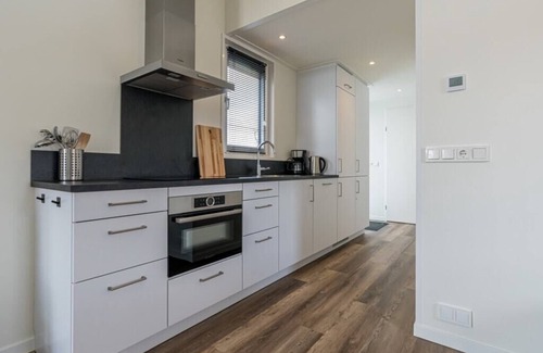 Burgh-Haamstede House | Spacious living room with a stylish interior, charming accents and a beautiful view of the expansive