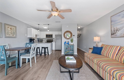 Ono Island Condo | Steps to Pools, Hot Tub, Beach | Poolside Palms | Garden Level Patio & Lawn Area
