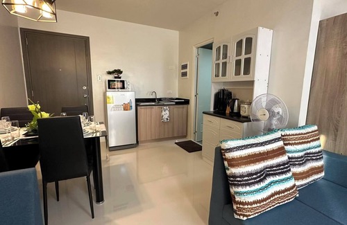 Puerto Princesa City Centre Condo | Studio 1queen Bed, sofa, kitchen and Balcony Puerto Princesa, Palawan