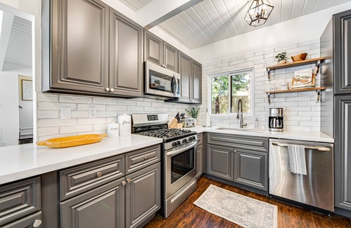 Cedar Glen House | Stunning lakehouse lodge with a deck, fireplace, lush patio & lake access