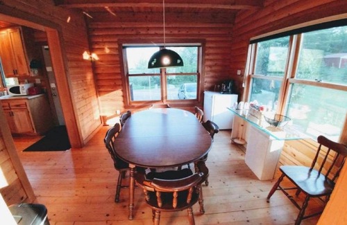 Grantsburg Cabin | Stunning log home with a rental pontoon on a quiet sunlit bay. Check it out!