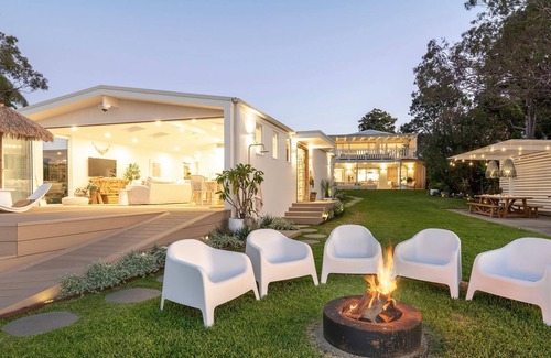 Bonnells Bay Apartment | The Boathouse- Unwind at this tranquil, absolute waterfront, luxury Boathouse nestled on the edge of