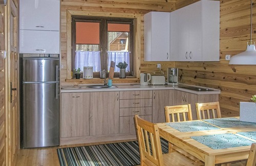 Ostroda House | The cozy wooden cottage is located in the village Ru.