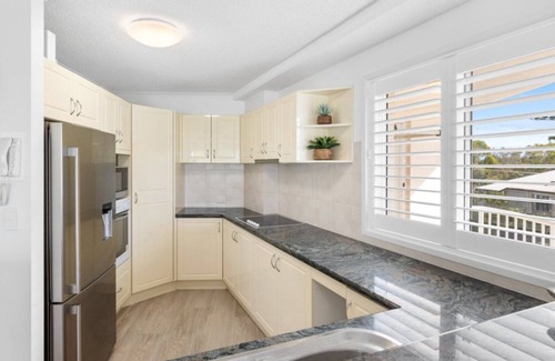 Currimundi Apartment | THE ENTRANCE UNIT 5 - Relax on a sunlit balcony overlooking Currimundi Lake, with birds singing in t
