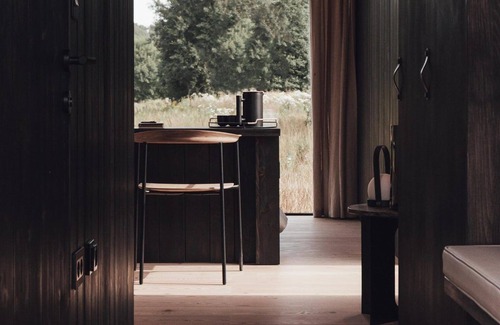 Wilsum Cabin | The Nokken Forest Cabin stands on the edge of the forest with unobstructed views over a rolling landscape. This cabin offers a lot of privacy due to its location. The large window is facing west. Enjoy the sunset over an endless cornfield from your b