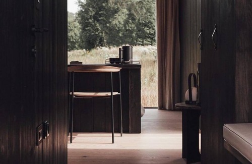 Wilsum Cabin | The Nokken Forest Cabin stands on the edge of the forest with unobstructed views over a rolling landscape. This cabin offers a lot of privacy due to its location. The large window is facing west. Enjoy the sunset over an endless cornfield from your b