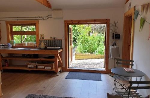 Kilgetty Apartment | The Potting Shed near Tenby, 100" Projector, Four poster bed, On-site HOT TUB access via Spa Pack