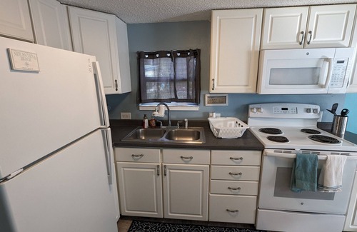Edgewater House | The Tiki Hut Oasis, a tropical Beach home with firepit, patio, and more!