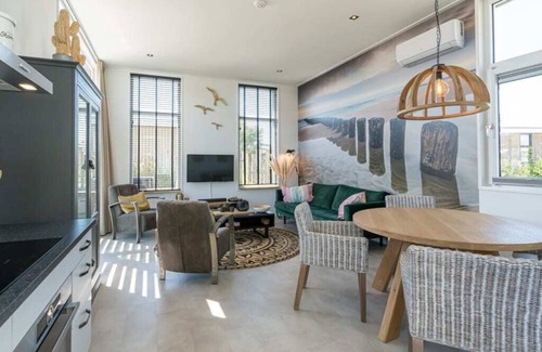 Burgh-Haamstede House | This chalet is beautifully finished both inside and outside. The landscaping, canopy, poster walls a