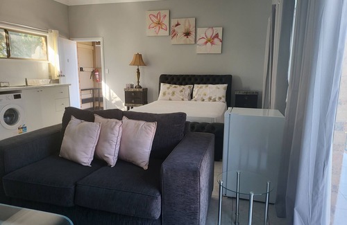 Windsor Apartment | Top View Deluxe Self-Contained Room No 3 with Balcony Overlooking Swimming Pool.