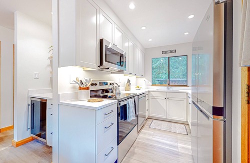 Warnick House | Tranquil forested oasis near rivers and trails with firepit, games, & wood stove
