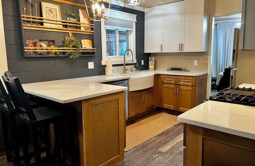 Howell House | Tranquil haven with a roomy deck and stunning panoramic lake views.