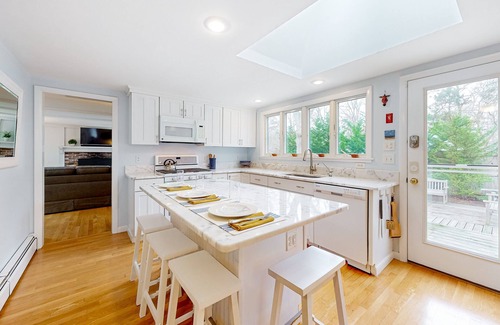 East Orleans House | Tranquil & sunlit home with peaceful yard, large deck, & fireplace - near beach