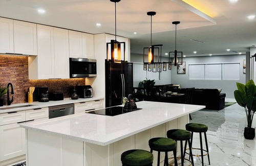 West Palm Beach Villa | Tropical Luxury Retreat with warm Pool, Spacious 5-bedroom & Mini Golf