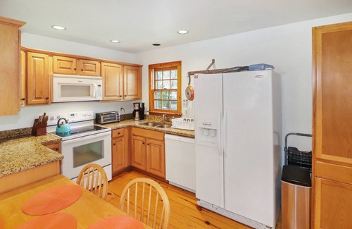 Chincoteague House | Utter East - great home with large screened porch and firepit next to the pond
