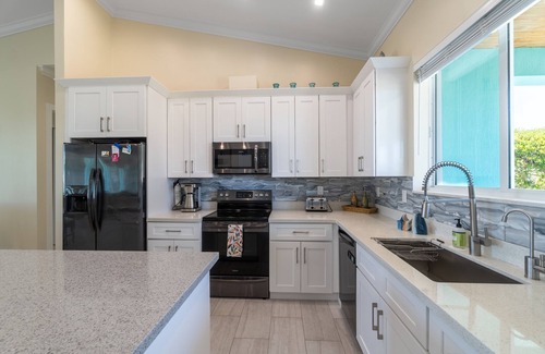 Breezeswept Beach Estates House | Villa Lucie | Canalfront home w/5 bedrooms + pool + boat lift