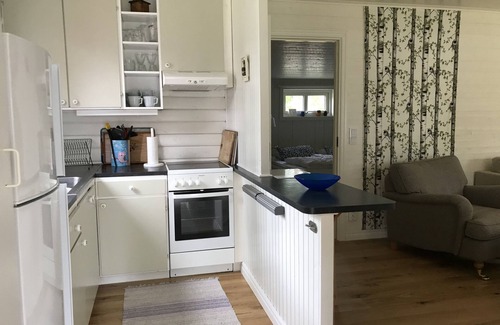 Hestra House | Winter garden and living room with view on the lake, 2 bedrooms.