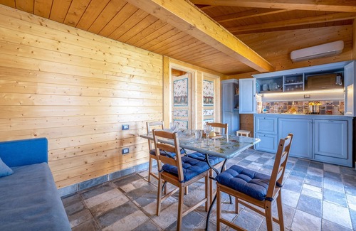 San Brizio Apartment | Wooden house with porch and garden