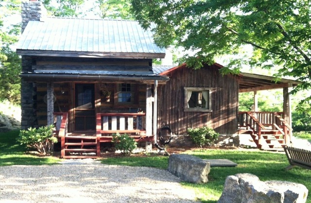1800’s restored log cabin on 26 private rolling wooded acres with sunset views