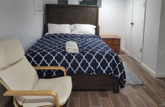 A cozy basement with queen-size beds Free WiFi, and a Smart TV with Roku.